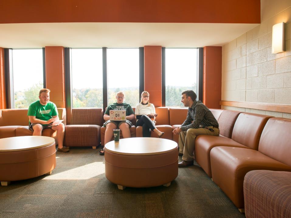 Students sitting indoors on couches