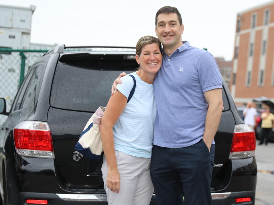 Two parents are posing for a picture during move in day