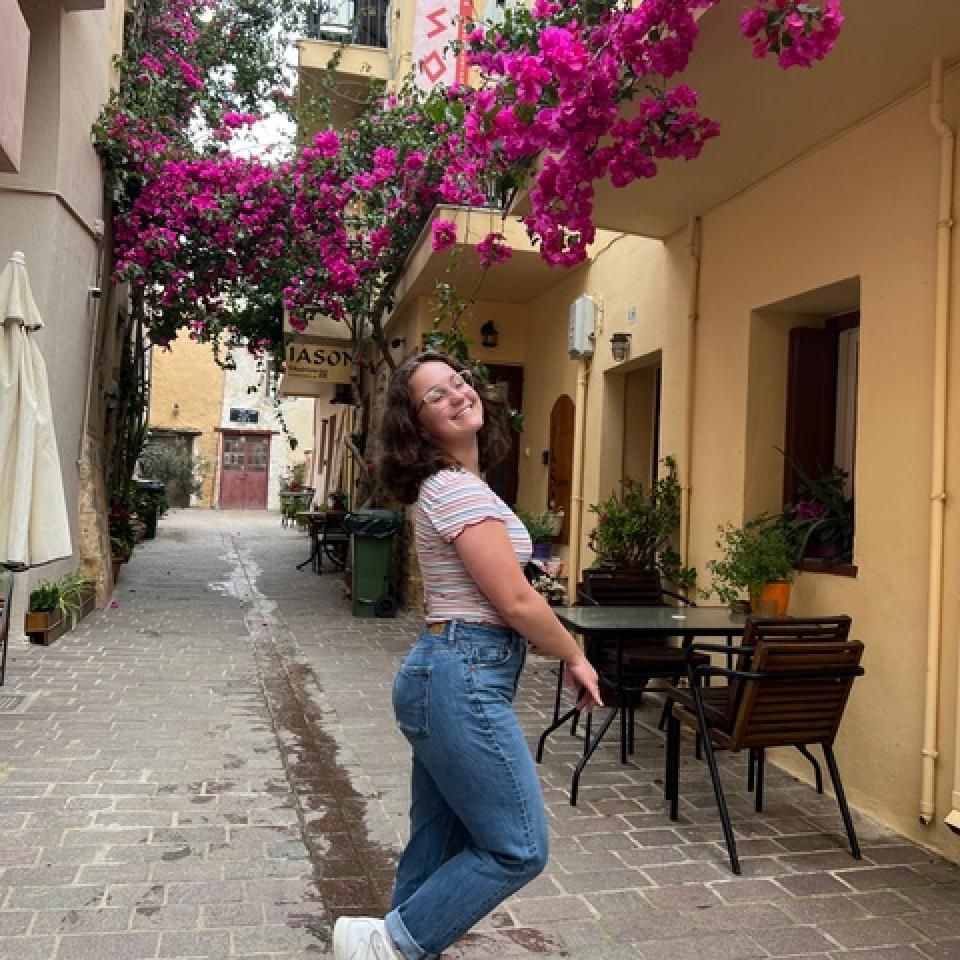 Gia Levis smiles on a street of Crete in Greece.