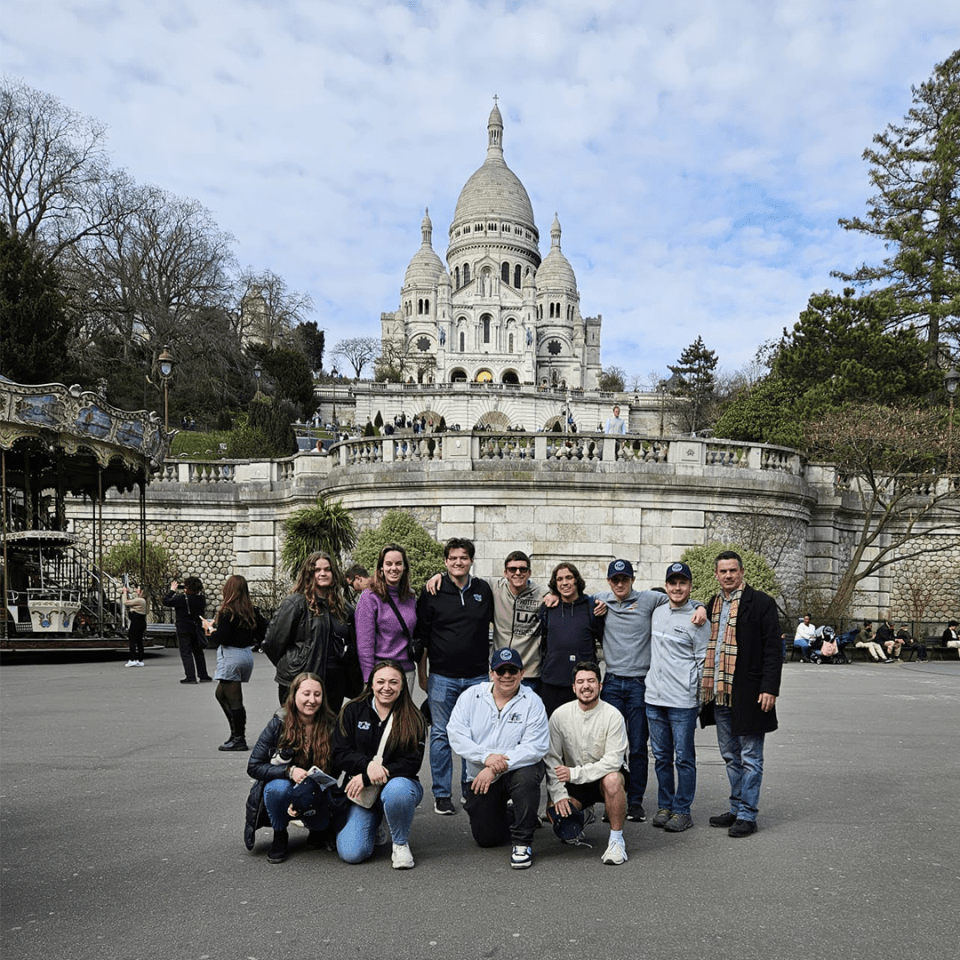 Students from the International Sport and Entertainment course at York College pose with their professor in front of a European building.