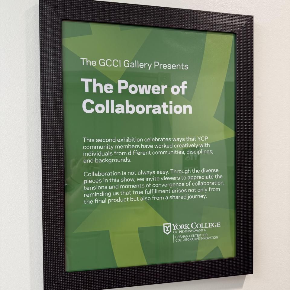 Framed green poster titled “The Power of Collaboration” from the GCCI Gallery at York College of Pennsylvania, highlighting a campus exhibition that celebrates creative, cross-disciplinary collaboration and the value of shared journeys.