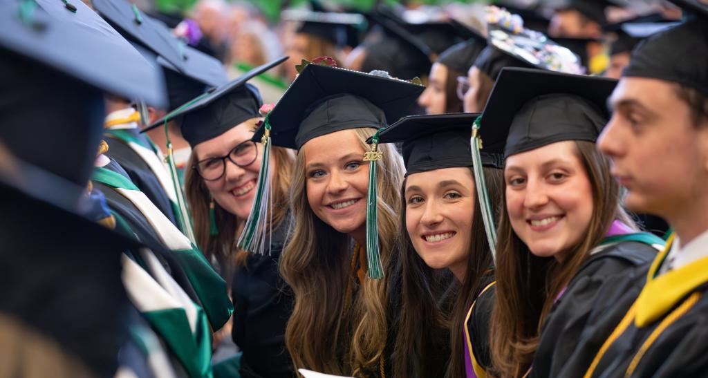 A group of girls smiles at the camera for Spring Commencement