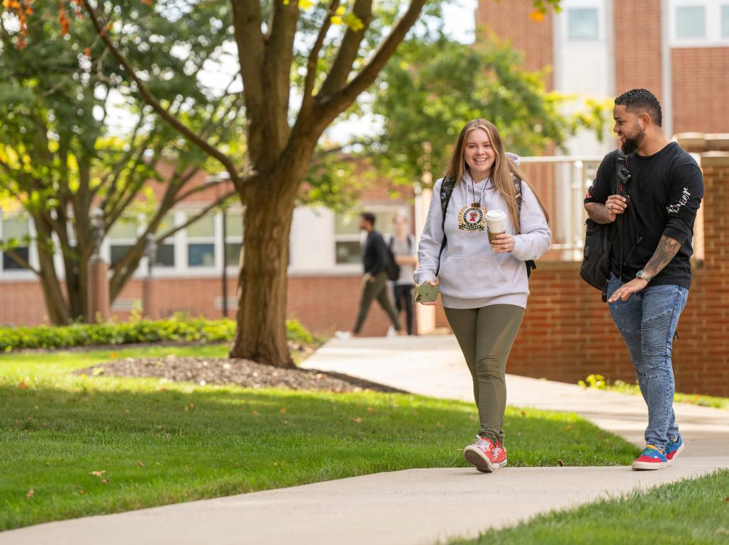 Kadith Mendoza and Hannah Mendoza-Orozco walk through the campus quad.