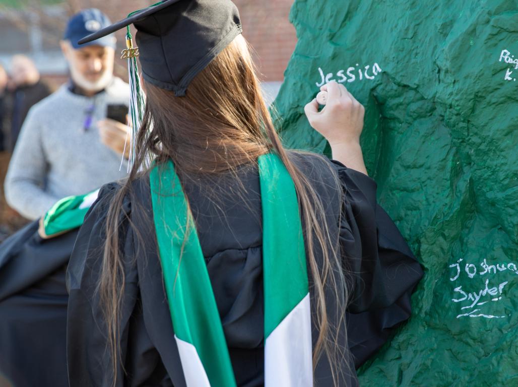 A York College graduate signs the rock