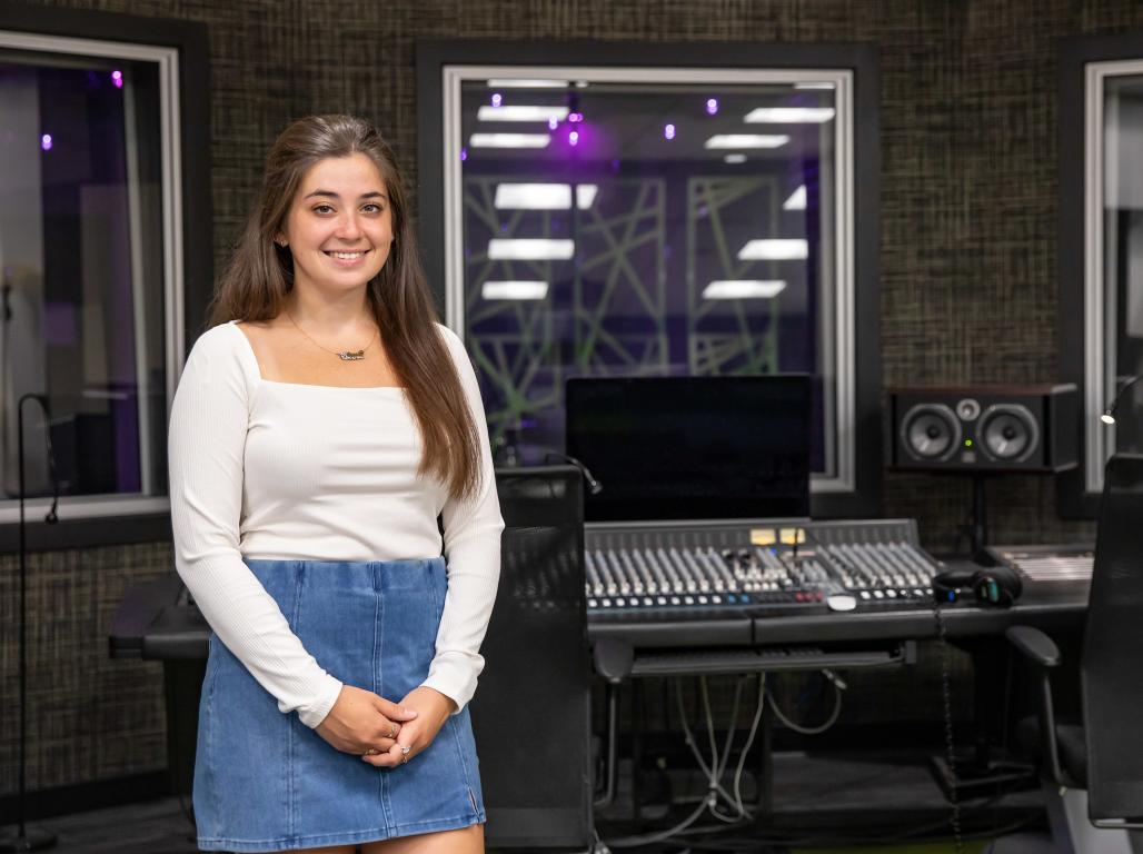 Alexa Scranton poses for a photo in the music recording booth.
