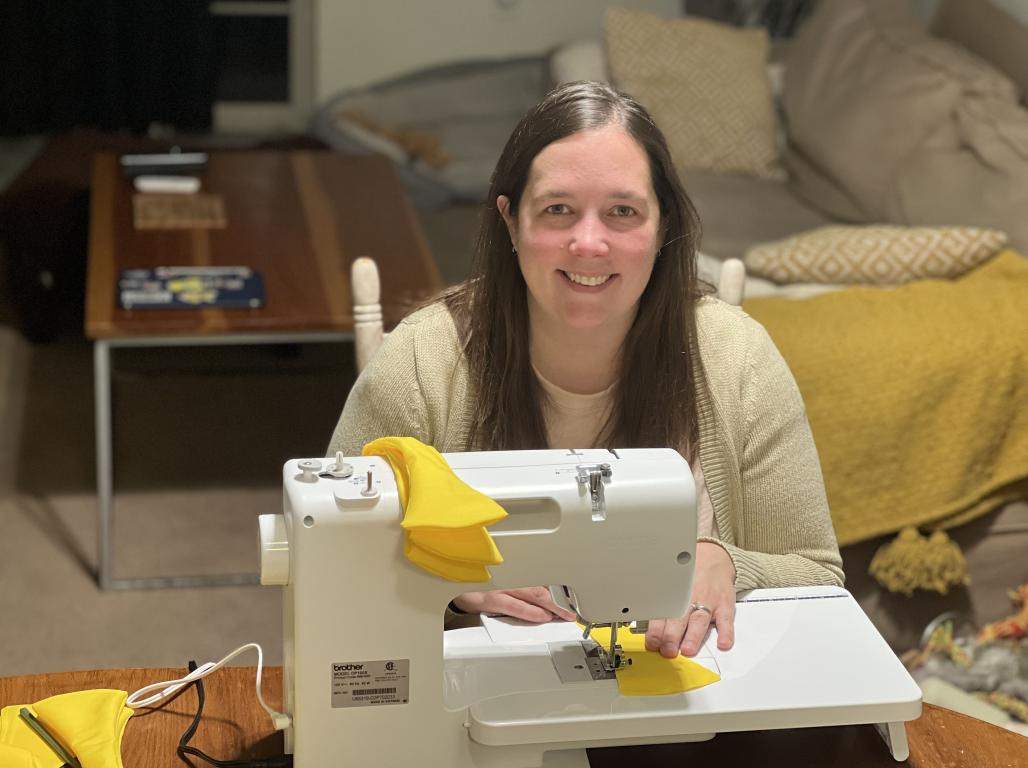 Caitlyn Bishop at a sewing machine making artwork 