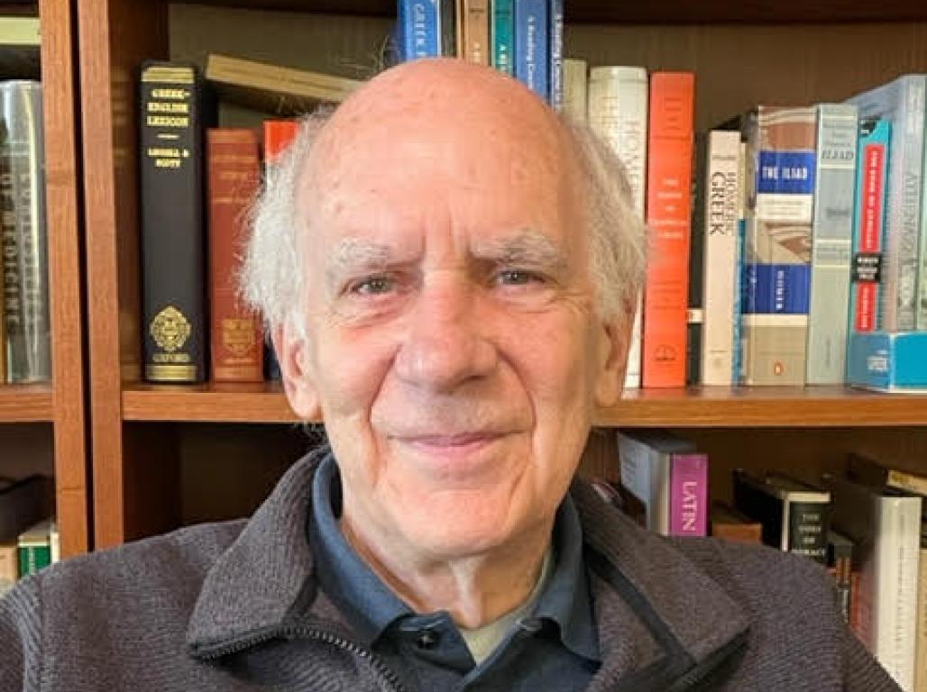 A portrait of Dennis Drabelle in front of a bookcase.