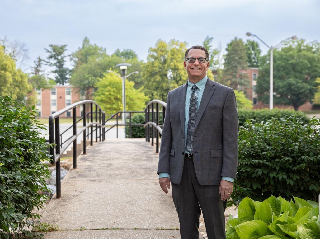 Dr. Burns standing in front of the Tyler Run Creek Bridge.