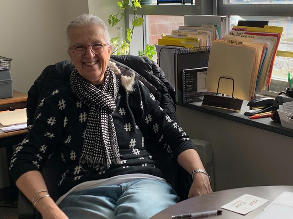 Mel Rodgers leans back in her desk chair and smiles.