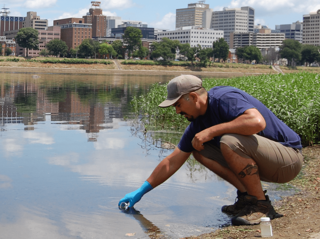 Ted Evgeniadis collects a water sample from Codurus Creek, a tributary of the Susquehanna river.