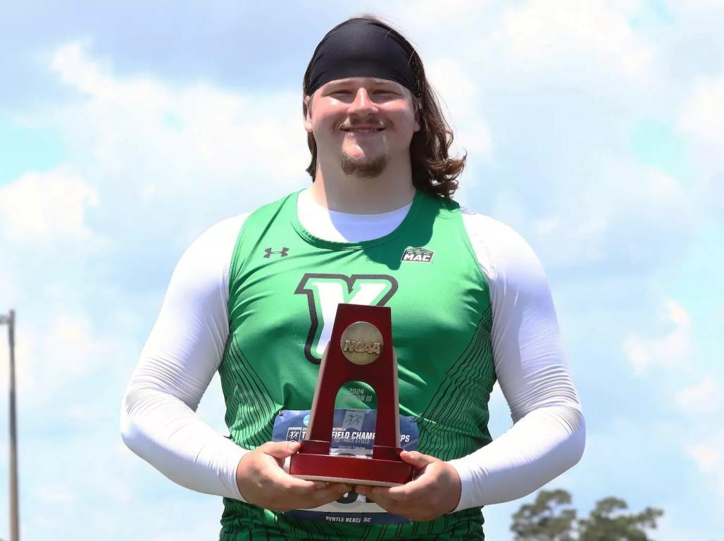 Andrew Mott holding up a trophy.