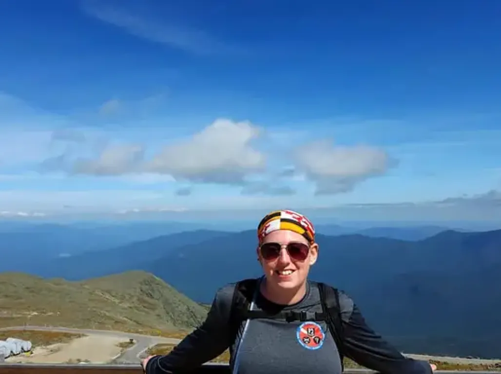 Stephanie Soder in front of a large mountain valley.