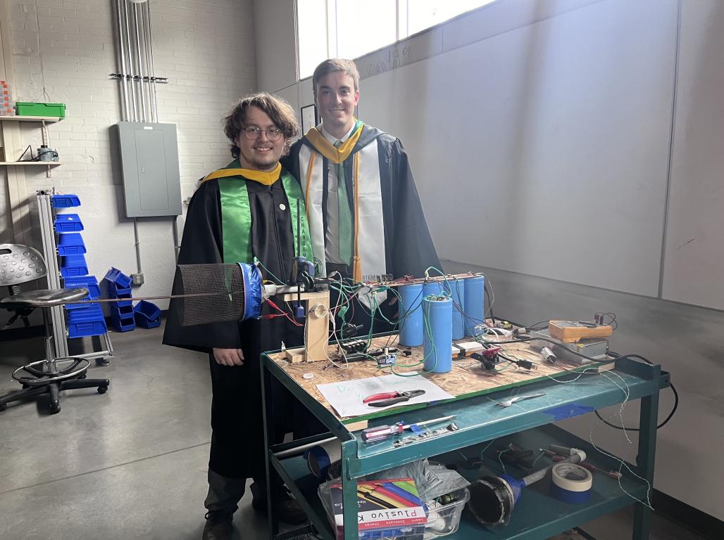 Hoopman and MacNeal in an Engineering Lab while dressed in their regalia.