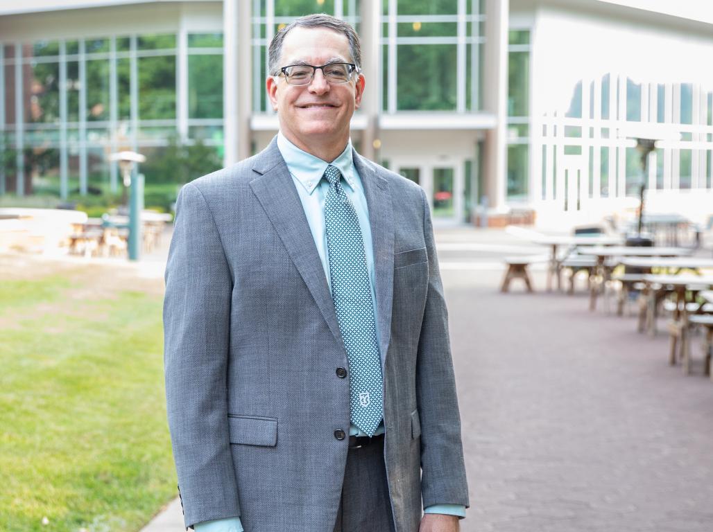 Dr. Thomas D. Burns standing in front of the Waldner Performing Arts Center