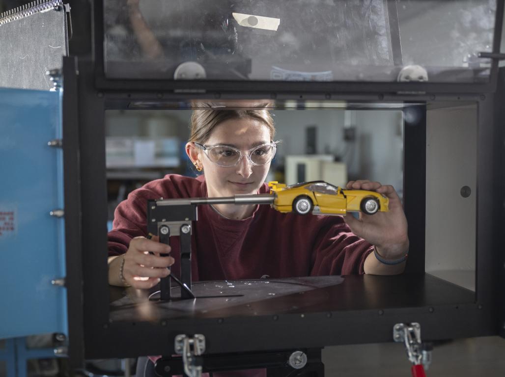 Graduating senior Nina Bell works on a toy car