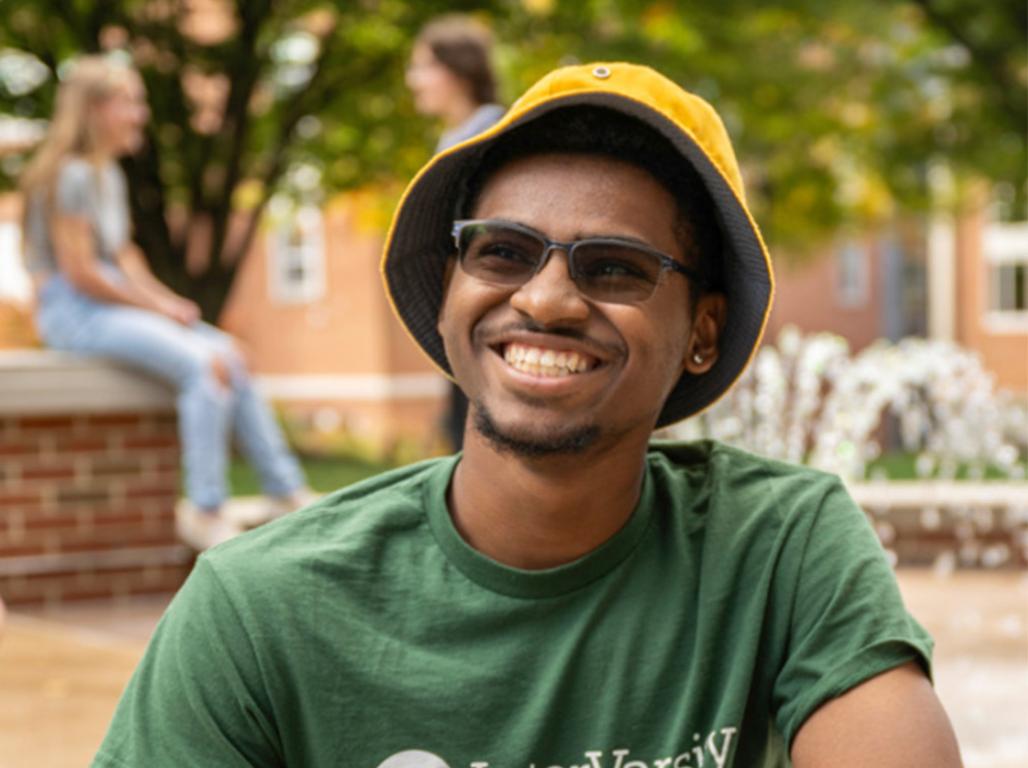 Graduating senior Robert Fields sits near the fountain