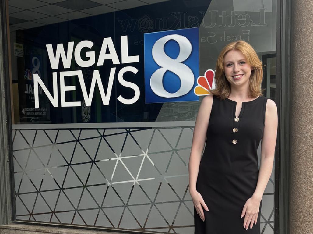 Morrissey Walsh stands in front of a WGAL News 8 sign.