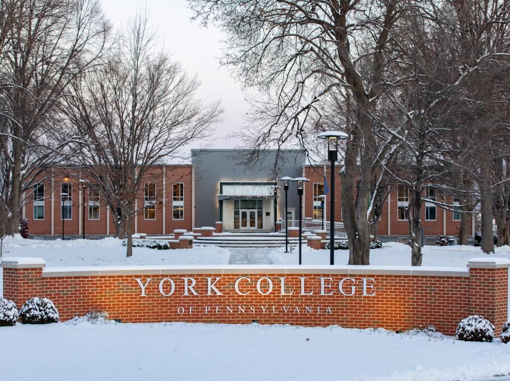 A snowy day at the York College Campus with the Schmidt Library visible in the background.