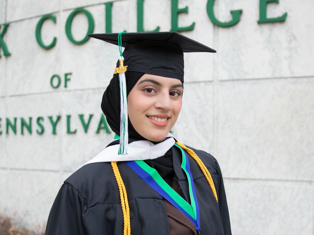 Medical Humanities Major Laiba Khan '25 wears regalia for a graduation portrait.