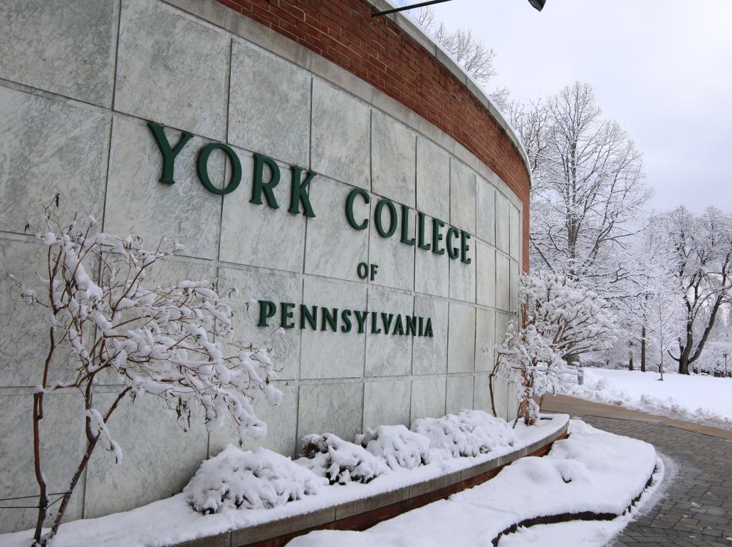 York College of Pennsylvania exterior signage on a snowy winter day.