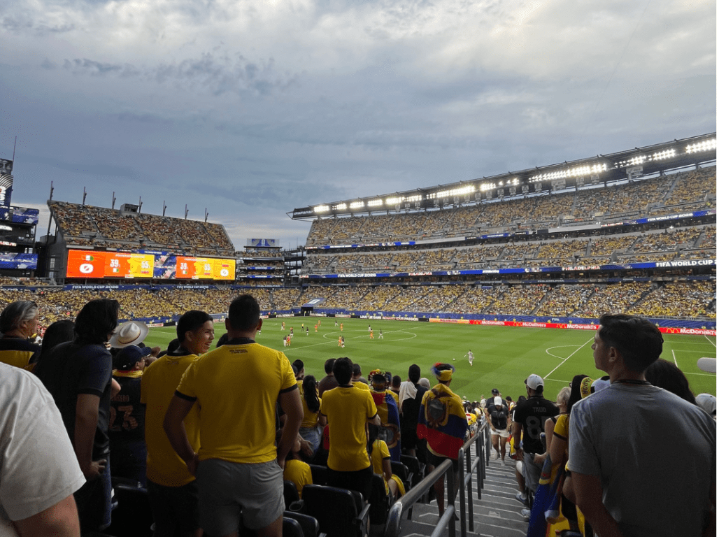 Fans fill the stands during a FIFA World Cup match in Philadelphia, with spectators watching the game from the stadium seating area.