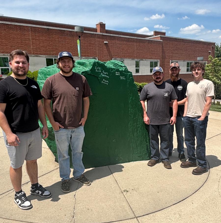Seniors—Owen Brady, Eric Kane, Nate Renfro, Dakota Sawyers, and Sam Thomas stand together with Ol' Spart