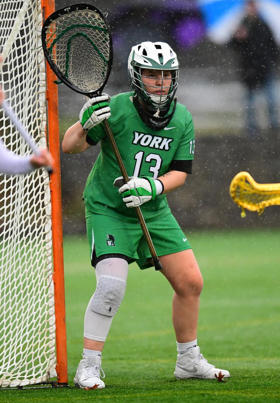 Women's Lacrosse player Bella Garbo guards the net as goalie