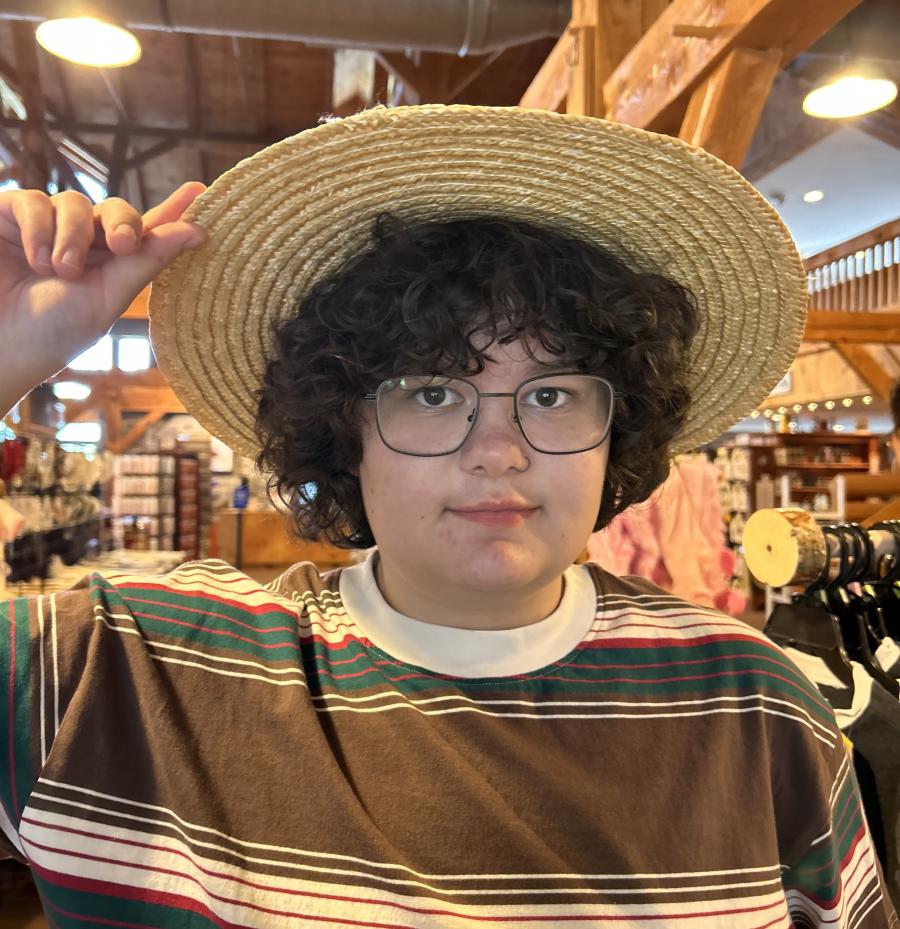 Student Isis Brewer facing the camera, wearing a hat.