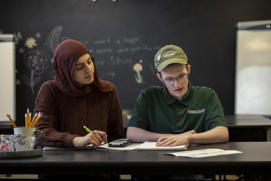 One student tutoring another at the Academic Success Center.