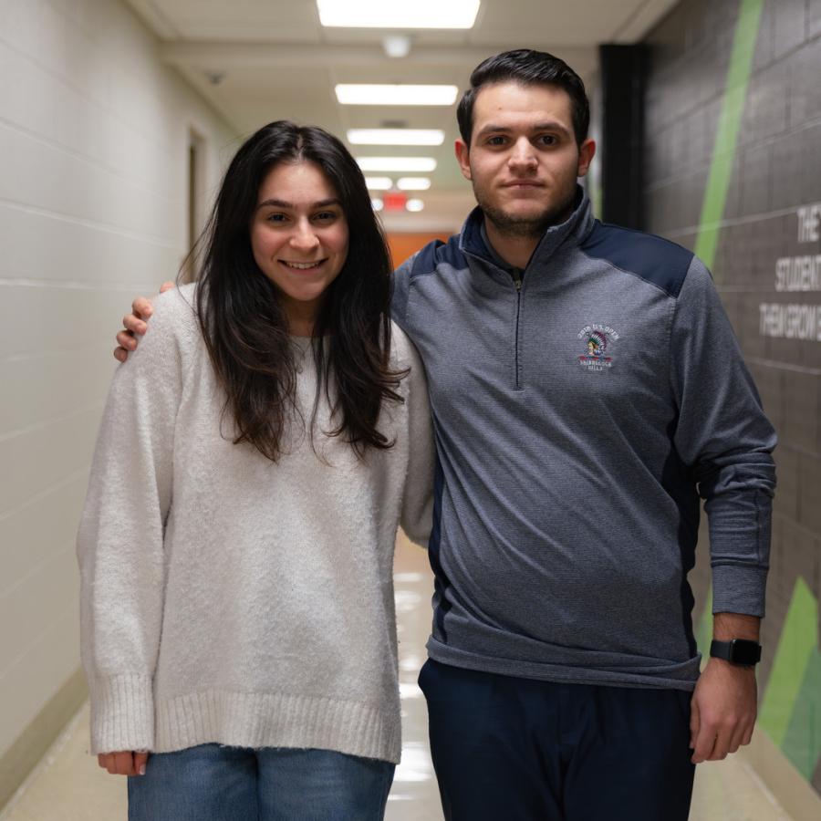 Twins Alexander and Victoria Jolakian stand side by side