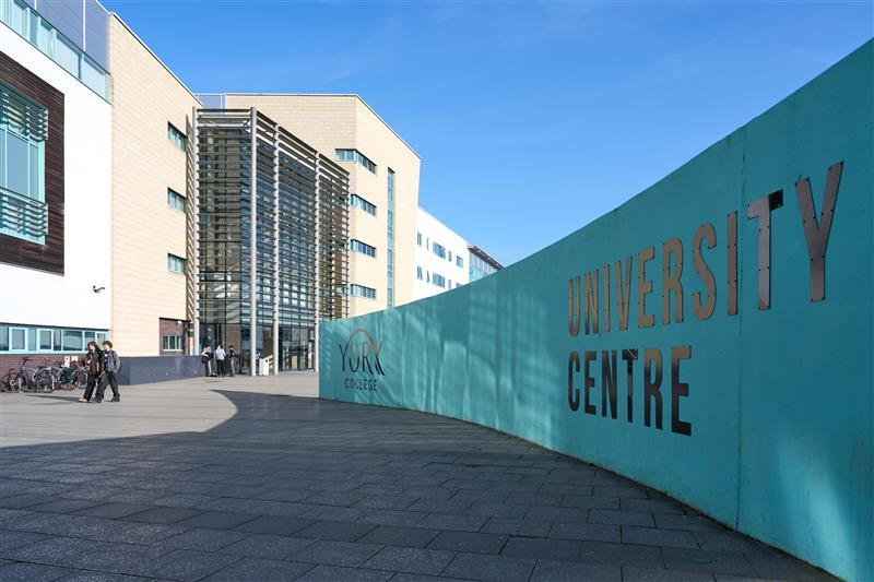 York College UK exterior signage. "University Centre" is visible in silver lettering against a teal background.