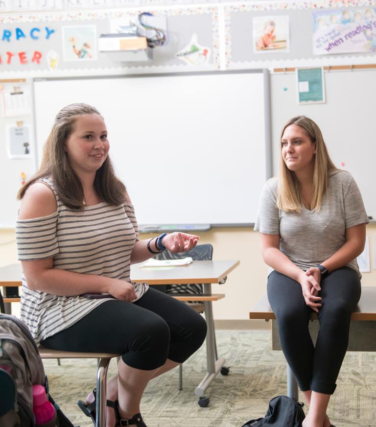 A group of student teachers in a classroom working together.