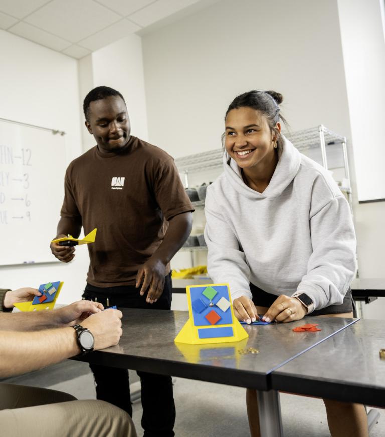 Two students work together on supply chain issues