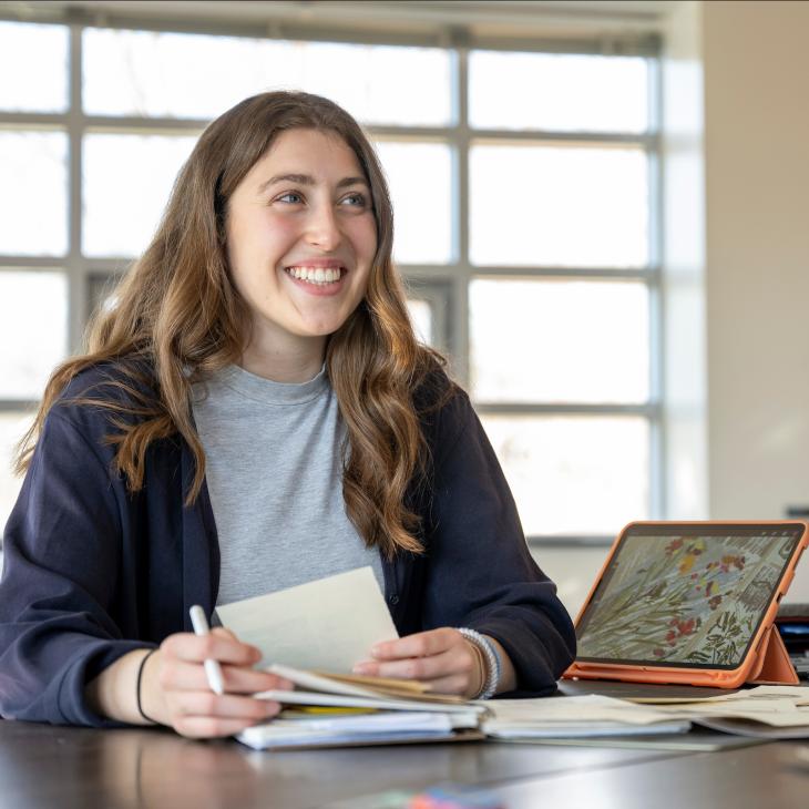 A student in a class smiling.