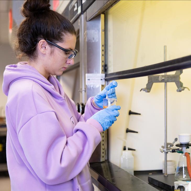 A student is studying a chemical in a glass beaker