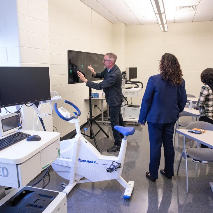The Exercise Lab director showcasing a new piece of equipment.
