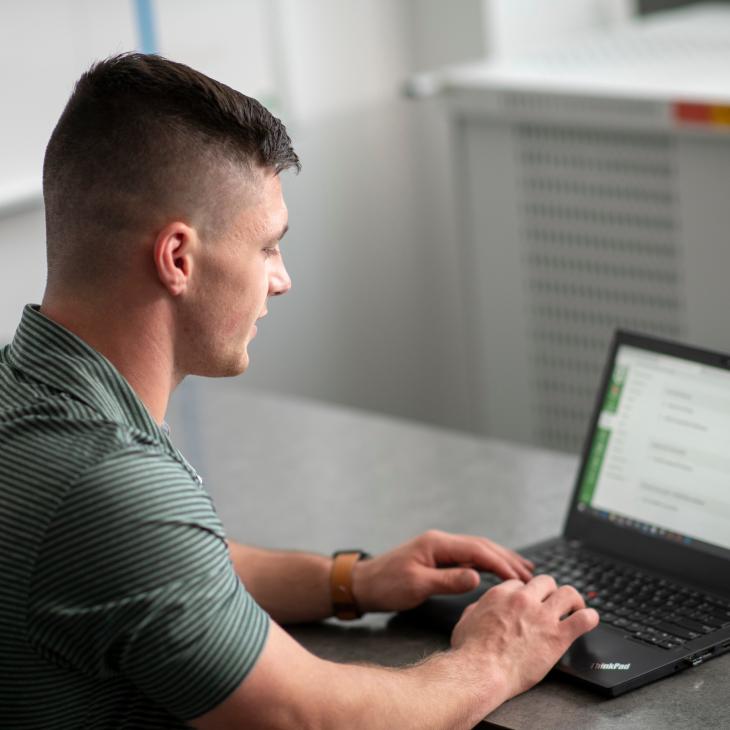 A student is in an advanced business class in the Willman Business Center