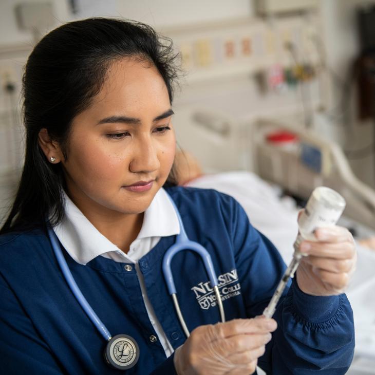 A student adding fluid to a shot.