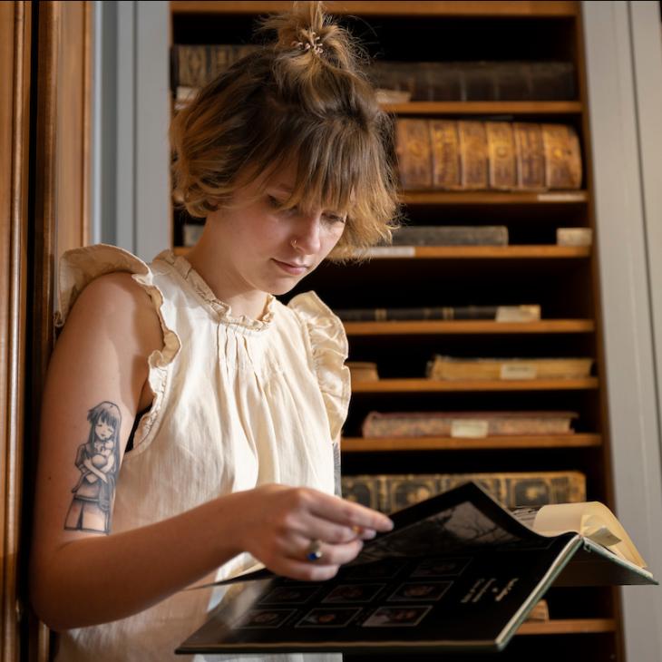 A student reading a book in the library.