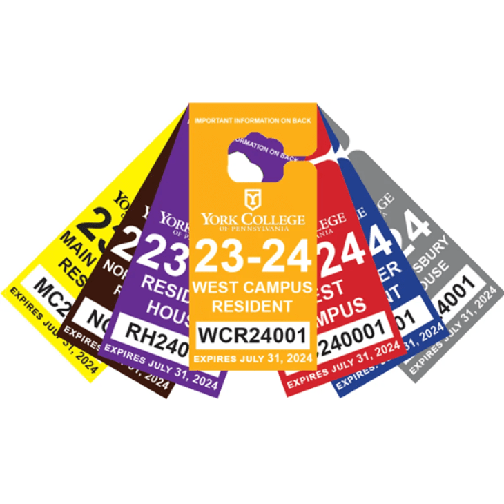 A stack of parking permits in a variety of colors.