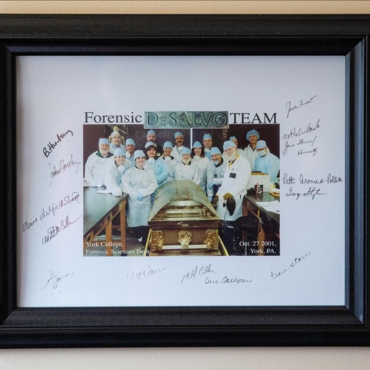 A picture of the Boston Strangler in a coffin surrounded by Forensic Team Members