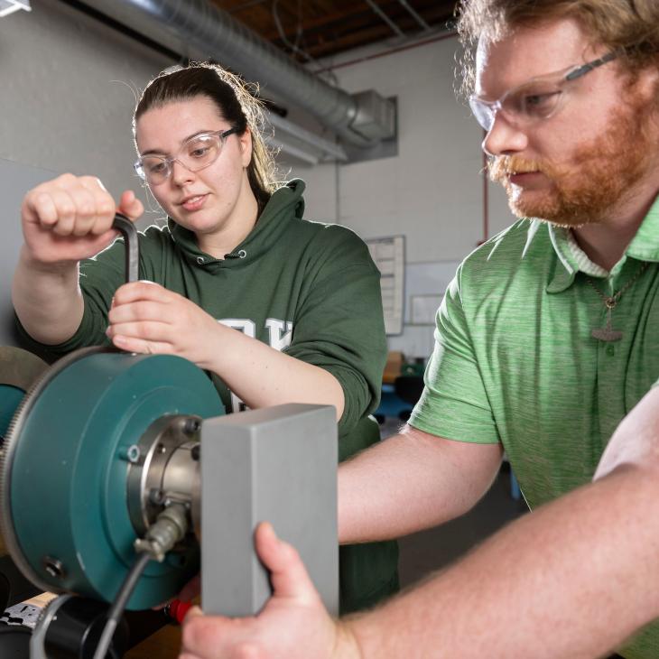 Two mechanical engineering students working in the lab