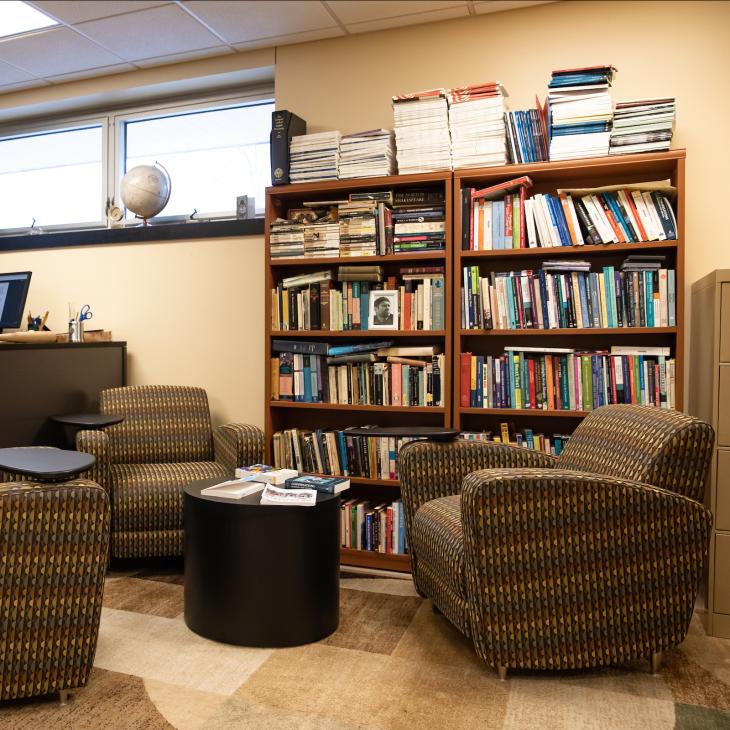 Dominic's bookshelf in his office on main campus.