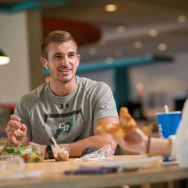 Two students sharing a meal in Johnson Dining Hall.