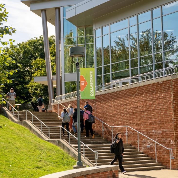 Students walking down the steps by the WPAC building.