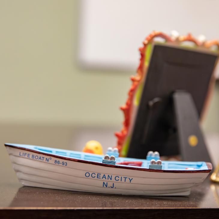A OCNJ lifeboat on a desk.