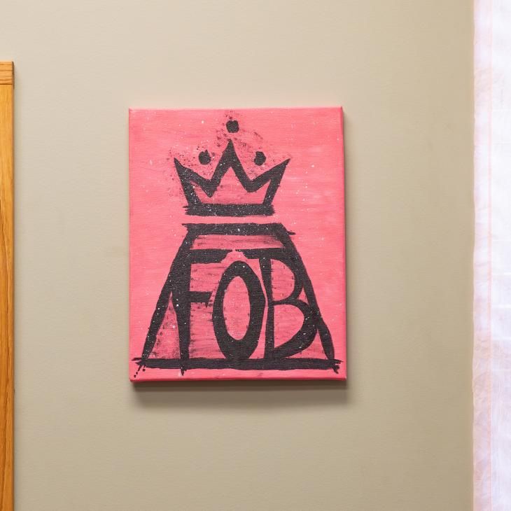 A Fall Out Boy painting hanging inside an office space.