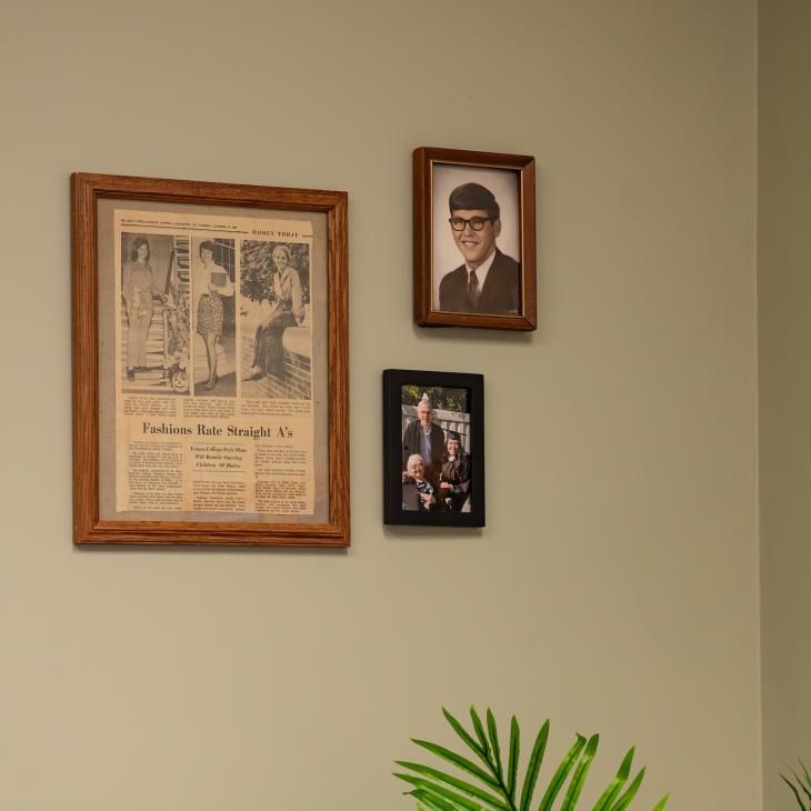 3 photos of grandparents hanging on a tan wall.