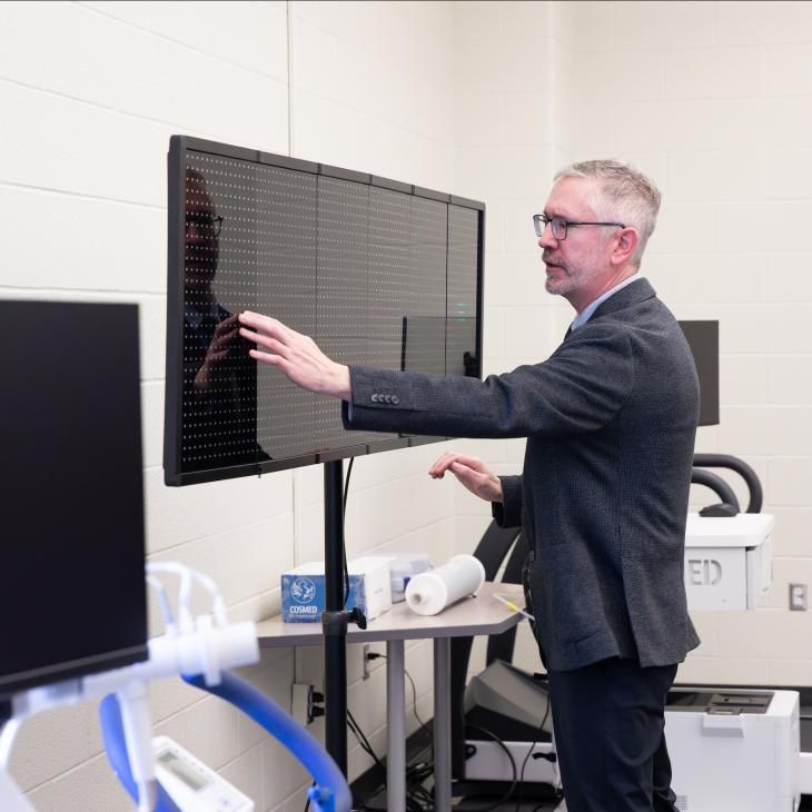 A man uses the large touchscreen in the Exercise Science Lab at York College.