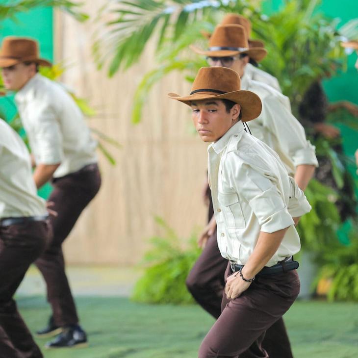 Roger Casado Sanchez wears traditional Dominican clothing and dances with a group of young men in the same costume.
